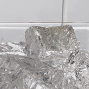 close up video of soda poured over ice cubes