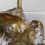 close up video of cola being poured over a glass of ice